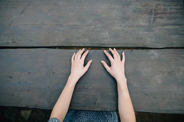 Womens gentle hands on an empty table of wood — Stock Photo, Image