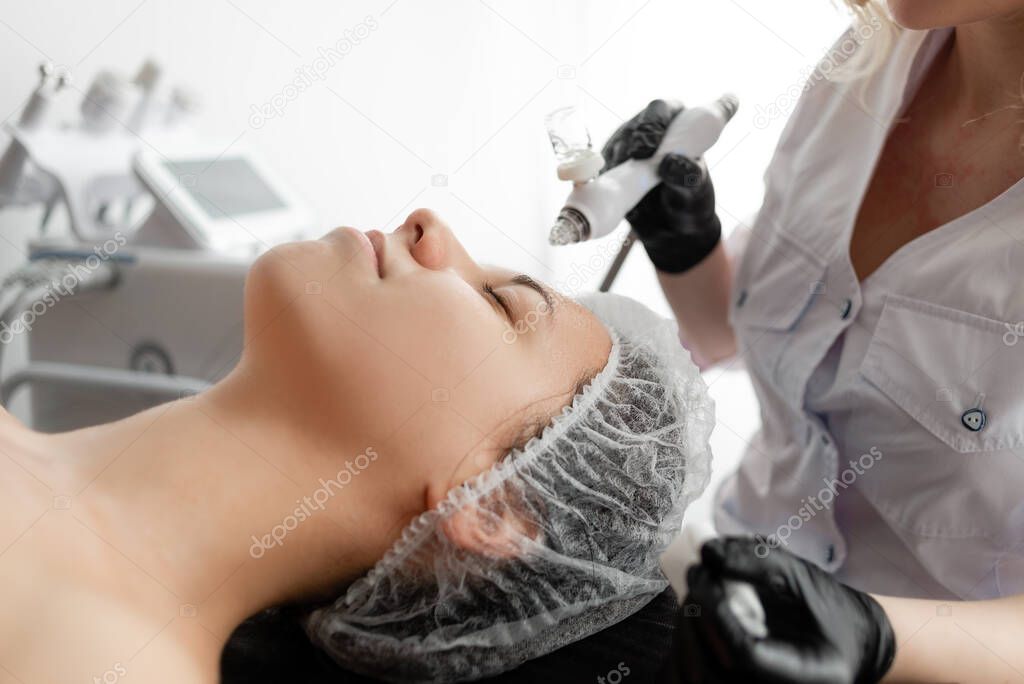 the girl is given hydrogen peeling to rejuvenate her face skin. non-invasive mesotherapy. oxygen therapy.