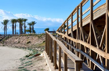 Wooden boardwalk leading to the Retamar beach. Almeria province clipart