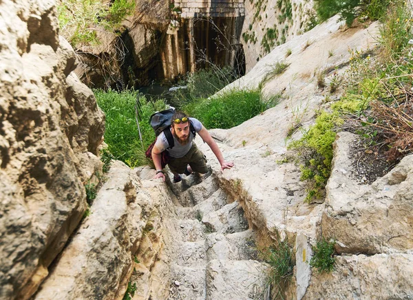 Man traveler climbing up a stepped mountain road. Spain — Stock Photo, Image