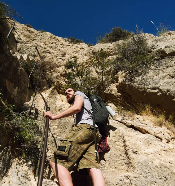 Homem viajante subindo uma estrada de montanha escalada. Espanha — Fotografia de Stock