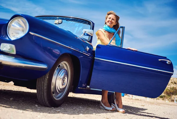 Красива жінка, сидячи в ретро кабріолетом автомобіля — стокове фото