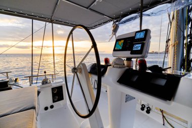 Idyllic scenery glowing sundown Ocean calm water view from catamaran flybridge open deck