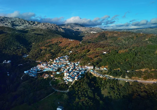 Aerial photography drone point of view of Juzcar town remarkable place all residential houses painted blue color, Valle del Genal, Serrania de Ronda, Malaga. Andalusia, southern Spain