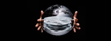 Kid holding globe map sphere isolated on black horizontal background. Ecological problems disasters. COVID-19 pandemic infection disease concept image, copy space for text clipart
