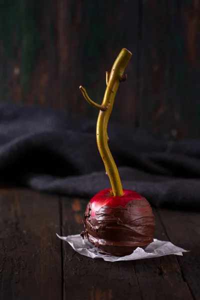 Red apple in black chocolate — Stock Photo, Image