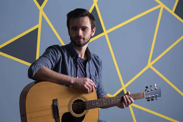 man with guitar and smile