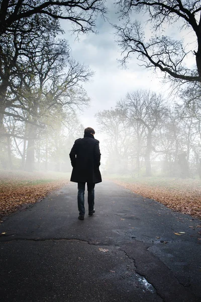 A man in a black coat — Stock Photo, Image