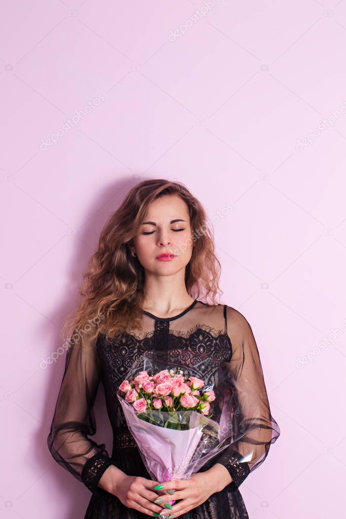 Woman with a bouquet with eyes closed
