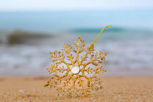 Christmas toy on a sandy beach — Stock Photo, Image