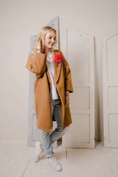 Blond-haired young woman with a red brooch — Stock Photo, Image