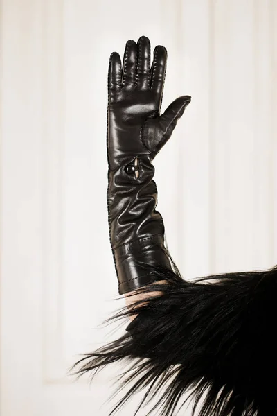 Hand in glove on a light background, close-up — Stockfoto