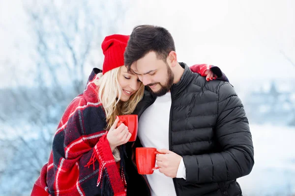 Couple at a picnic in winter they drink coffee — Stock Photo, Image