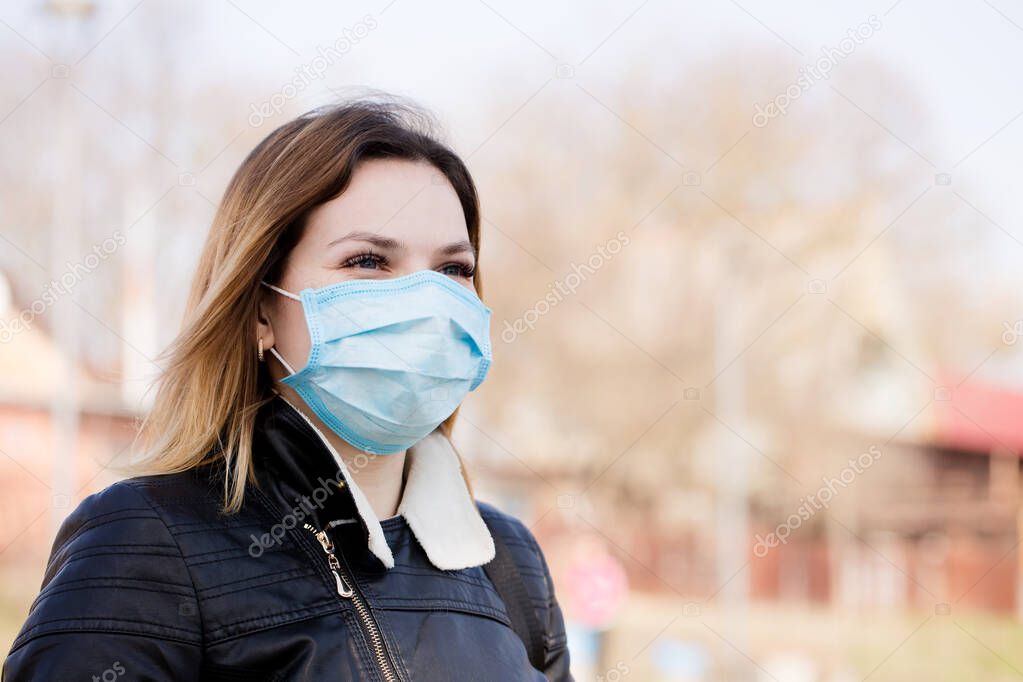 Young woman in a protective mask is walking. Coronavirus Protection Concept