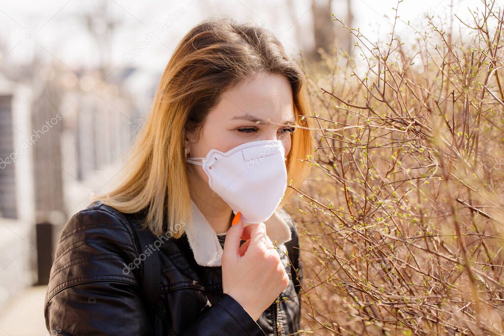 Young woman in a protective mask is walking. Coronavirus Protection Concept