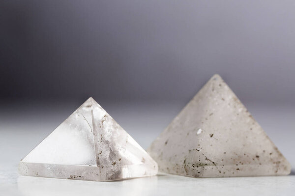 Natural rock crystal pyramid against a dark background, Reiki concept