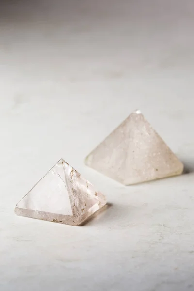 Natural rock crystal pyramid against a dark background, Reiki concept