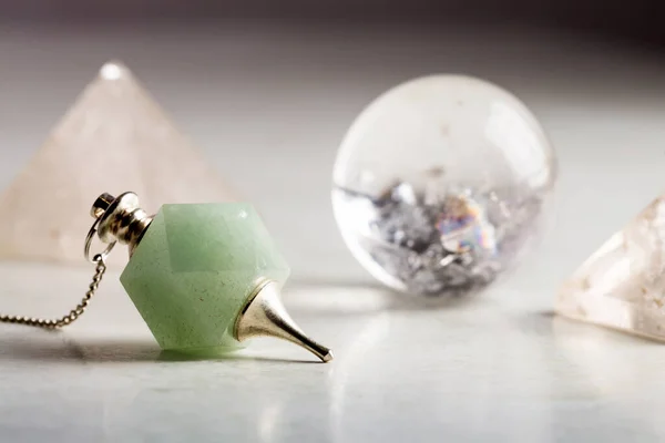 crystal ball, rock crystal pyramid and Pendulum, Reiki concept