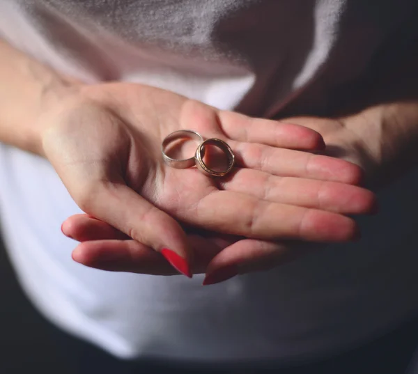 Woman hands holding wedding rings — Stock Photo, Image