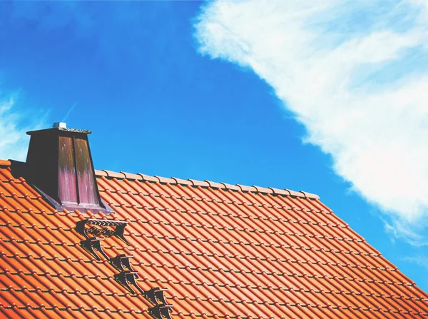 Techo de la casa contra el cielo azul brillante —  Fotos de Stock