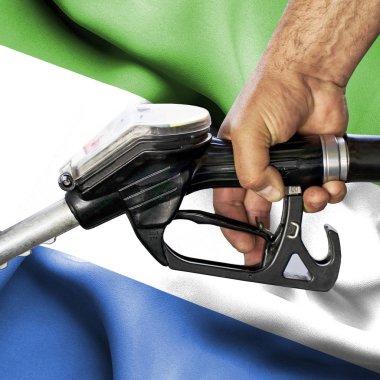 Benzin tüketimi kavramı - hortum karşı bayrak tutan el