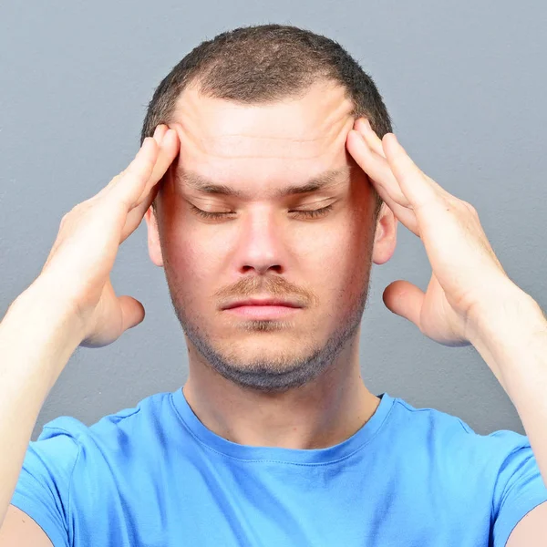 Portrait of a man putting fingers on foreheah and trying to conc — Stock Photo, Image