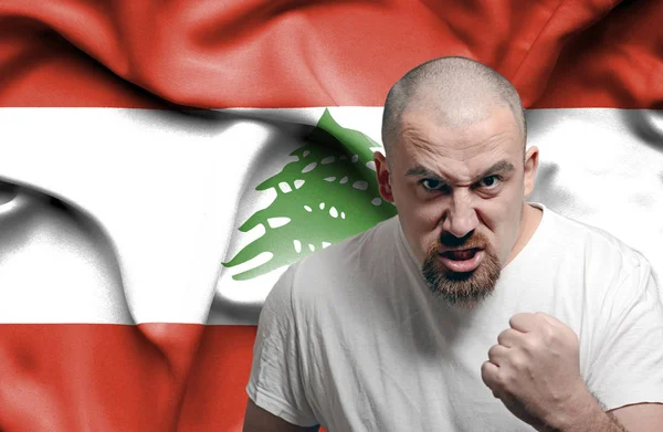 Angry man against flag of Lebanon — Stock Photo, Image