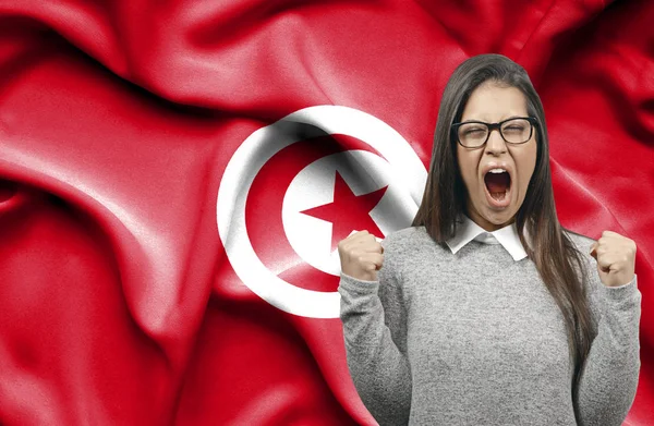 Ekstatyczny kobieta holidng pięści i krzyczeć przeciwko flaga Tunis — Zdjęcie stockowe