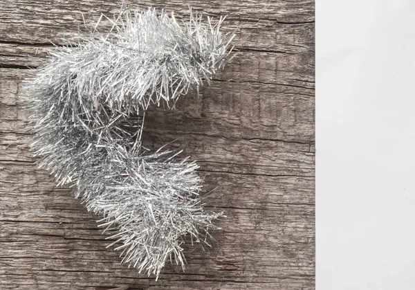 Christmas tinsel decorations on the wood — Stock Photo, Image