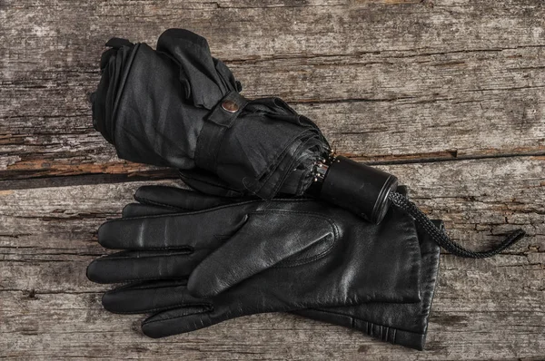 Umbrella and black womens leather gloves — Stock Photo, Image