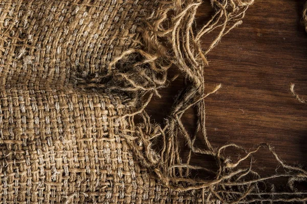 Burlap on old wooden table background — Stock Photo, Image