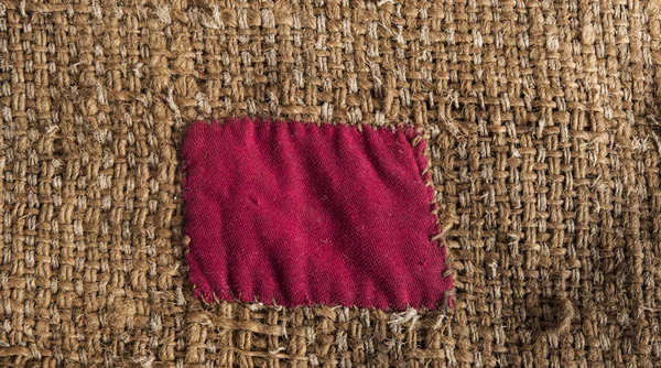 Burlap with red patch — Stock Photo, Image