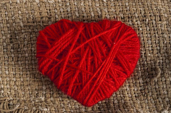 Red Valentine heart on burlap — Stock Photo, Image