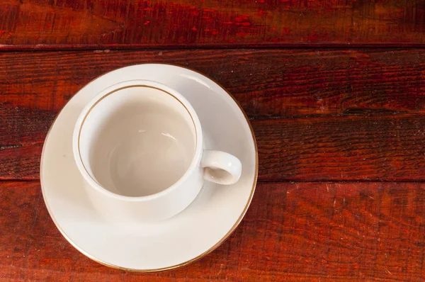 Empty coffee cup on a wood deck — Stock Photo, Image