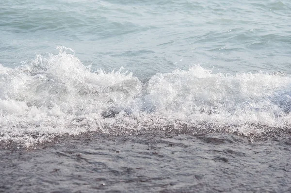 Schuimend zee kust bij het strand, close-up — Stockfoto