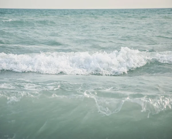 Wave on a pebble beach — Stock Photo, Image