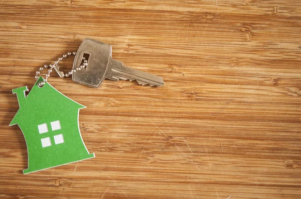 House-shaped key in the wood — Stock Photo, Image