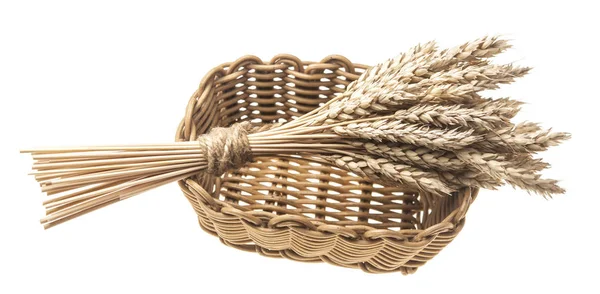 Sheaf of wheat in a wicker basket — Stock Photo, Image