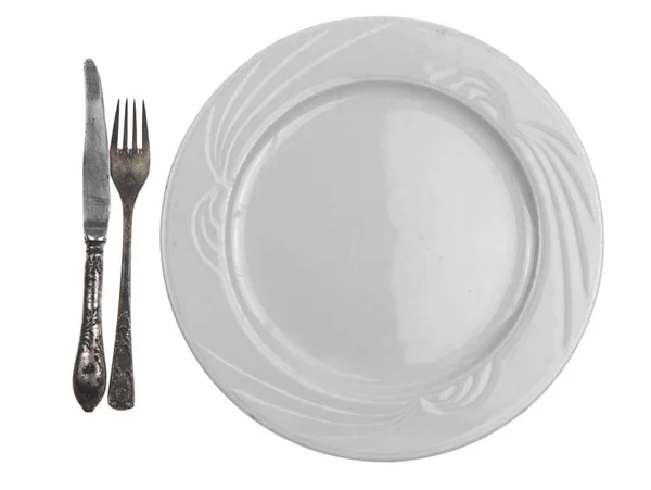 Vidlička a nůž na prázdný talíř — Stock fotografie