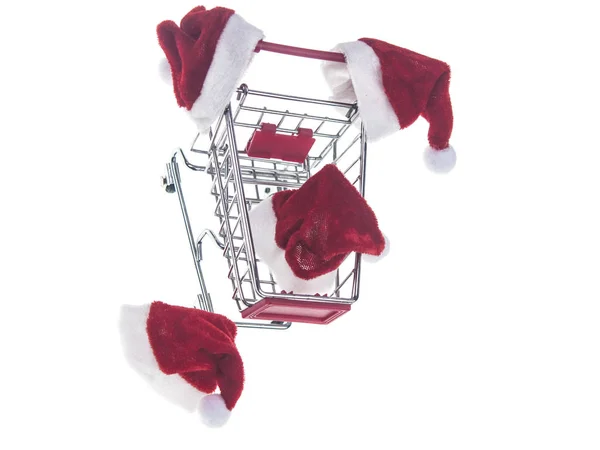 Shopping cart and Santa Claus hat isolated on white background — Stock Photo, Image