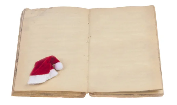 Cappello Babbo Natale e libro aperto isolato su bianco — Foto Stock