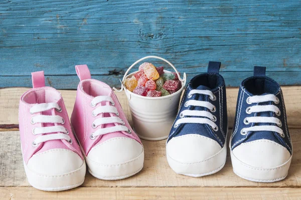 Buty dziecięce i kolorowe cukierki w wiaderku — Zdjęcie stockowe