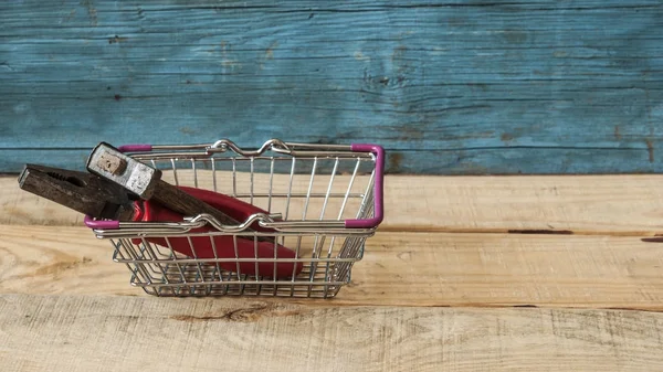 La cesta del supermercado tiene herramientas sobre fondo de madera . — Foto de Stock