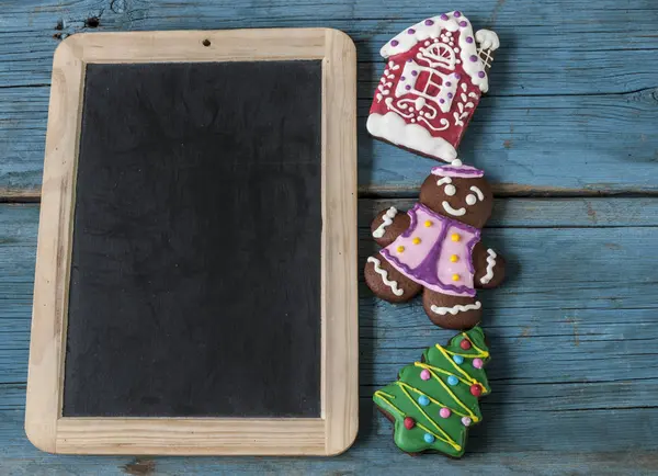 Christmas gingerbread cookies on old wooden background — Stock Photo, Image