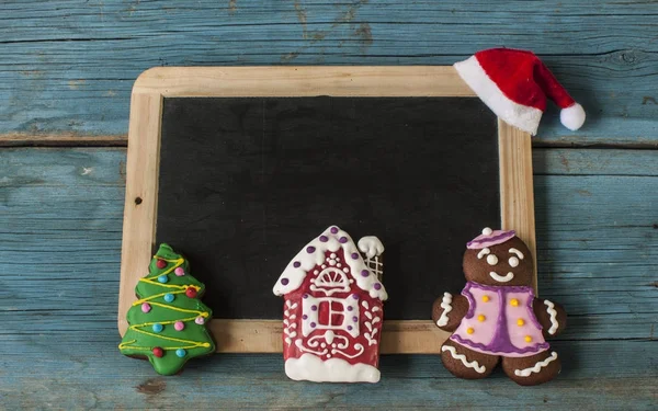 Christmas gingerbread cookies on old wooden background — Stock Photo, Image