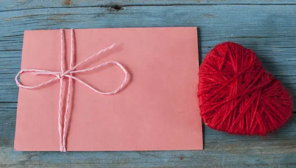Älska brev kuvert med rött hjärta på trä bakgrund — Stockfoto