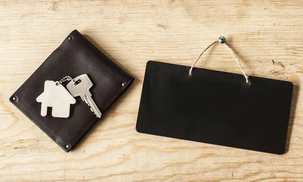 Wallet and key on wood background — Stock Photo, Image