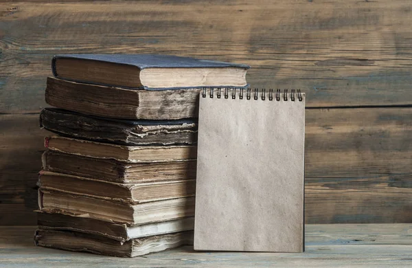 Old books on wooden planks background — Stock Photo, Image