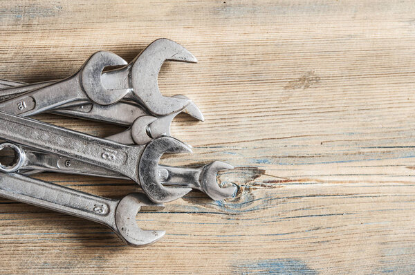 Wrenches on a wooden board