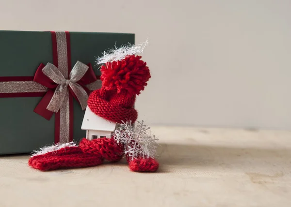 Close up conceptual miniature model house with red wool scarf ha — Stock Photo, Image